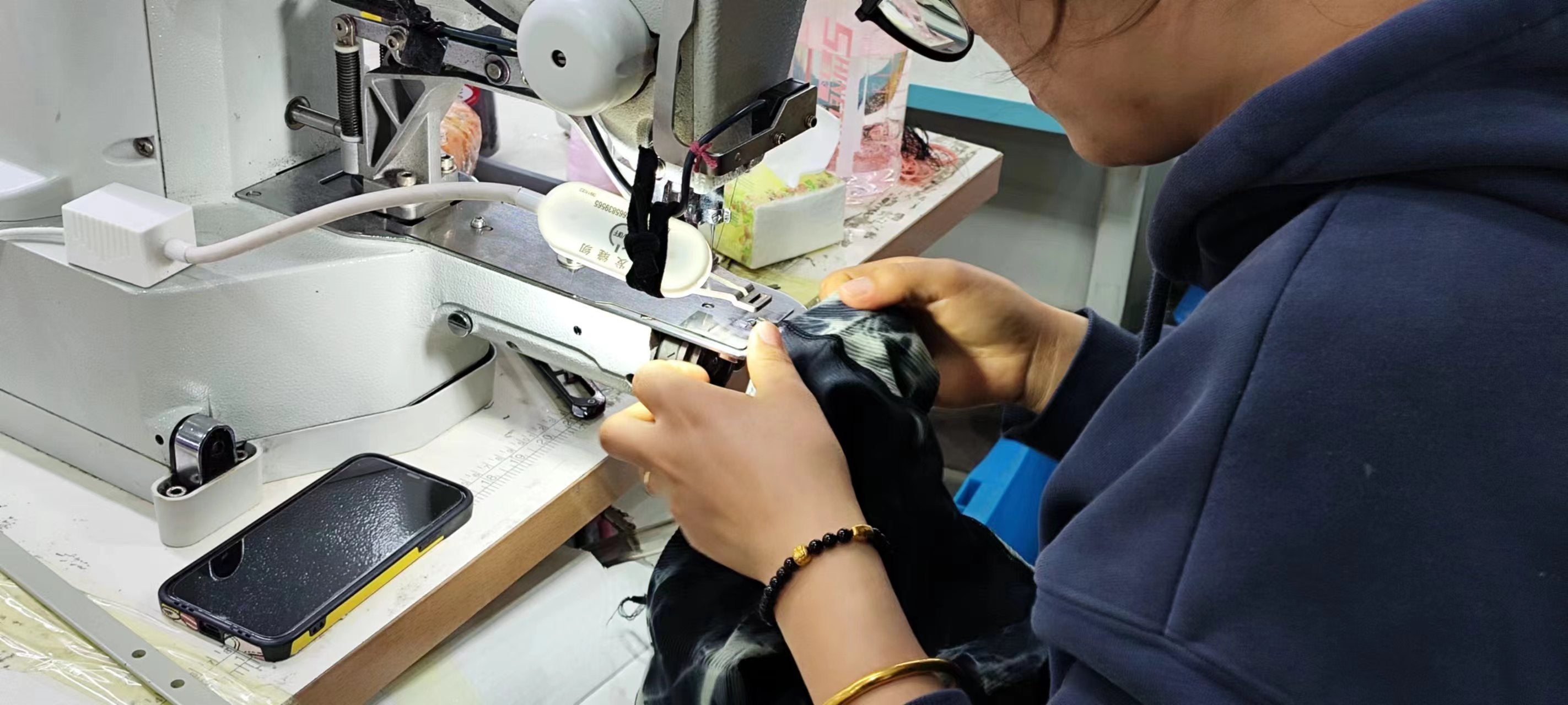 Garment worker sewing a detail at a machine